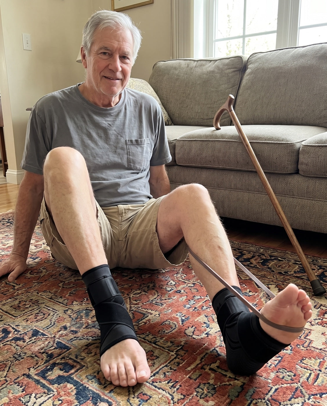 Man doing a seated foot stretch at home wearing a pair of Restride sleeves